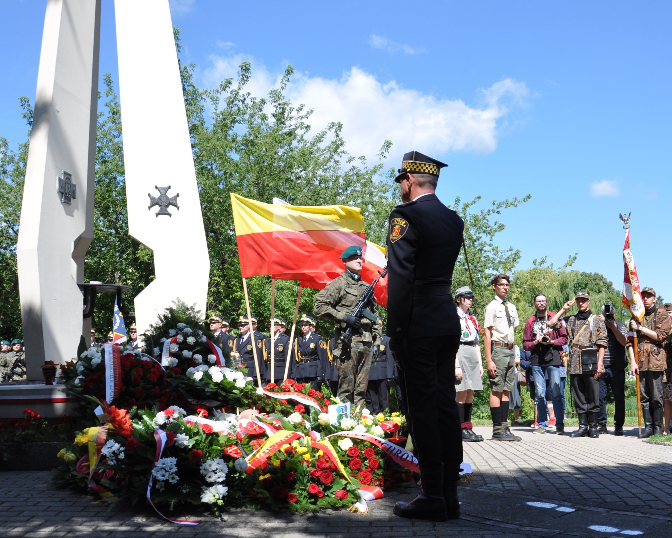 Strażnik miejski oddający salut przed pomnikiem Żołnierzy "Baszty" przy ulicy Dworkowej w Warszawie.